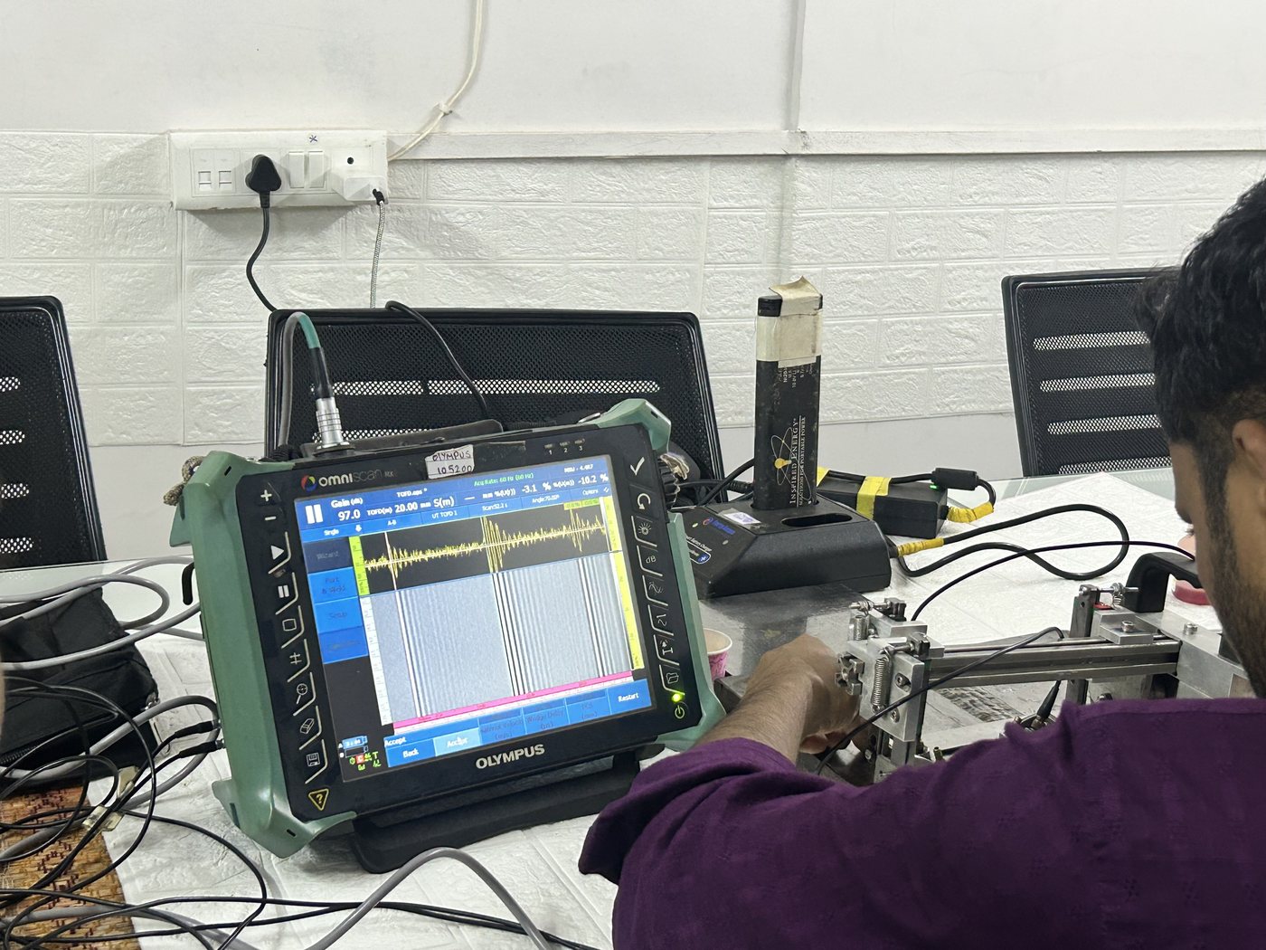 A-scan display on an Olympus OmniScan during a Spark NDT Phased Array Ultrasonic Testing practical, with probe and encoder on the specimen