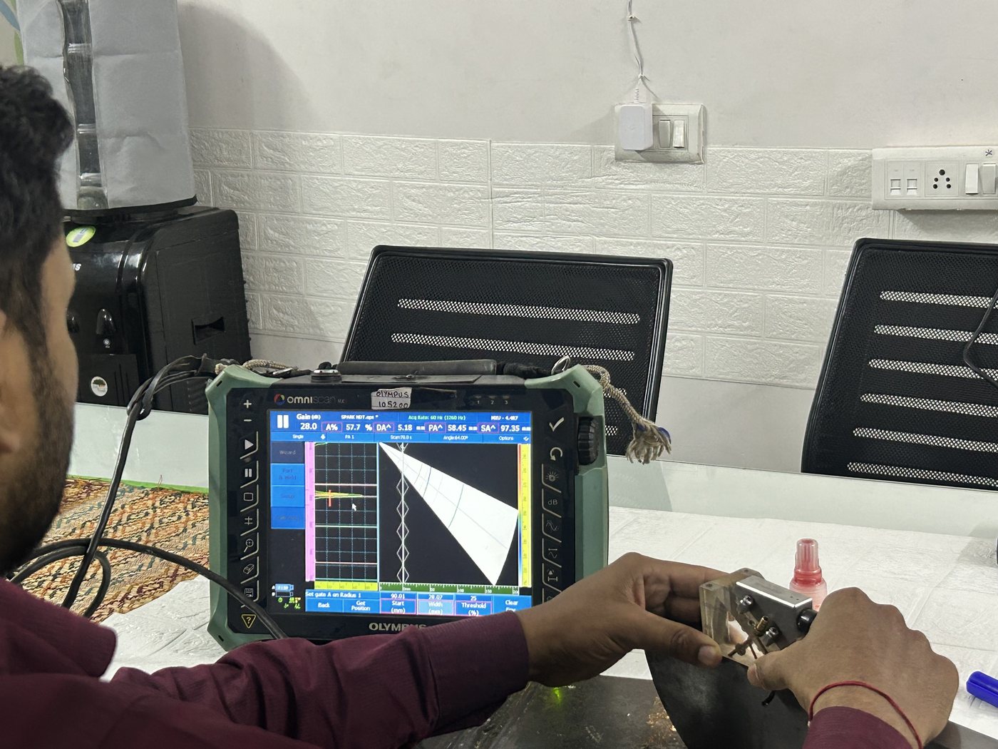 Spark NDT trainee at an Olympus OmniScan phased array instrument showing a sector scan during a PAUT and TOFD practical session